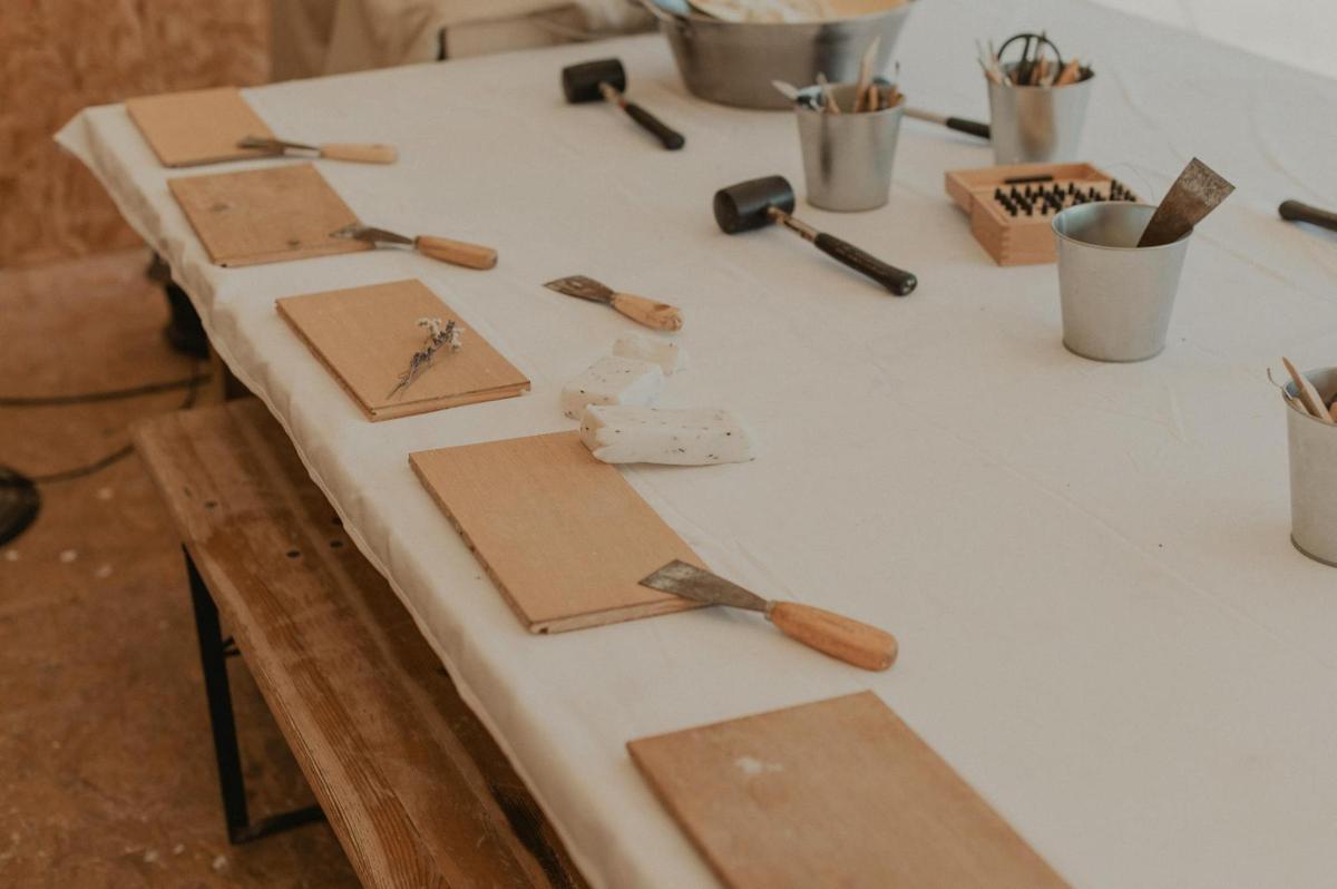 a white table with wooden utensils on it