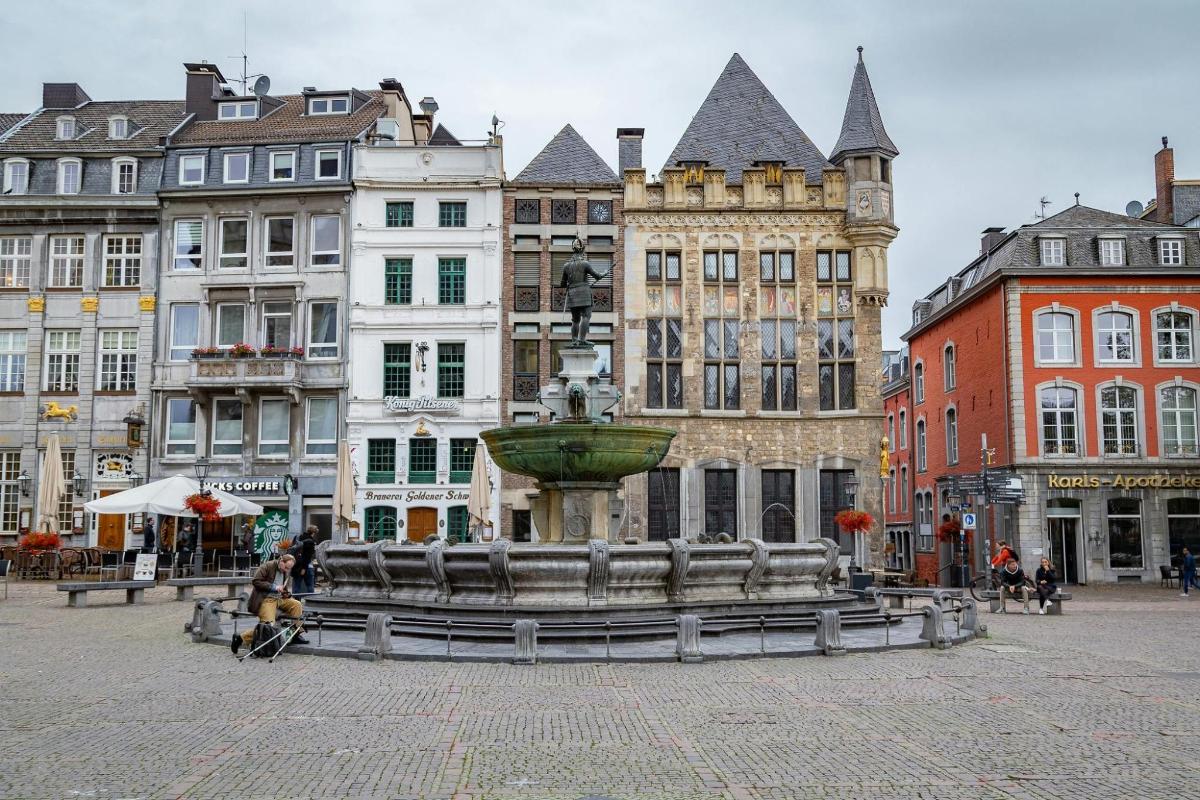 a fountain in the middle of a city with buildings