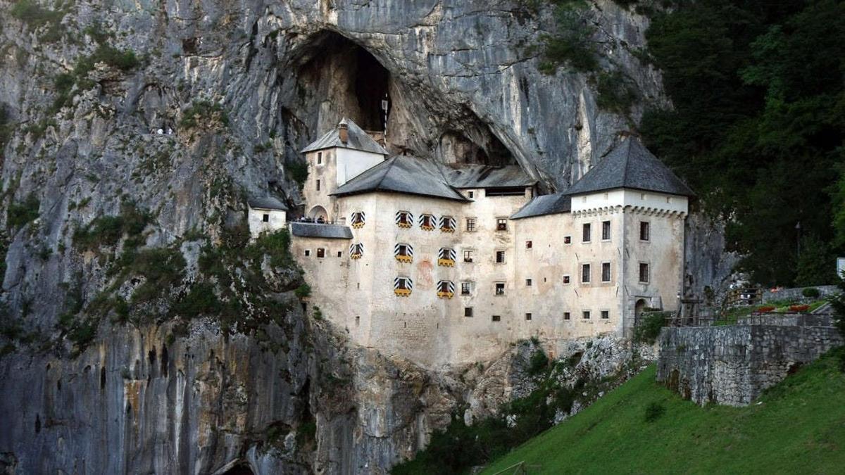a castle built into the side of a mountain
