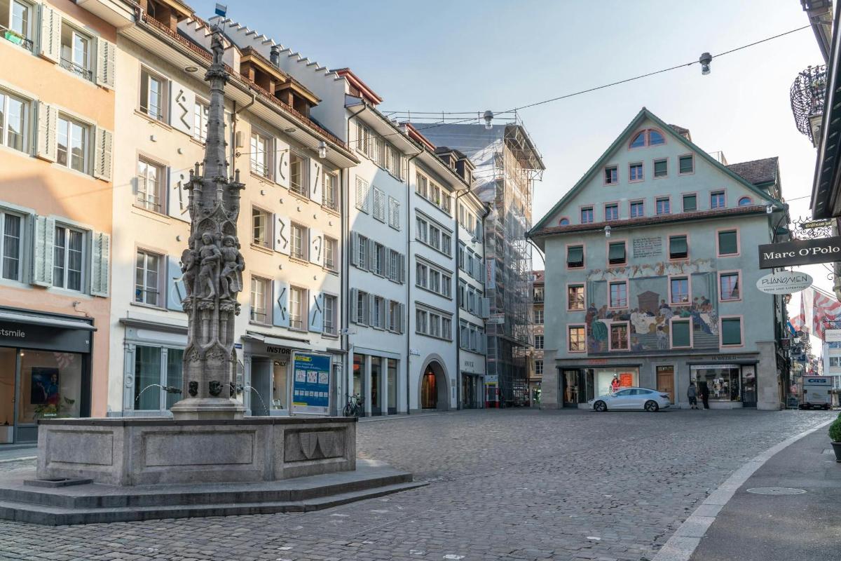 a street with a pole in the middle of a city
