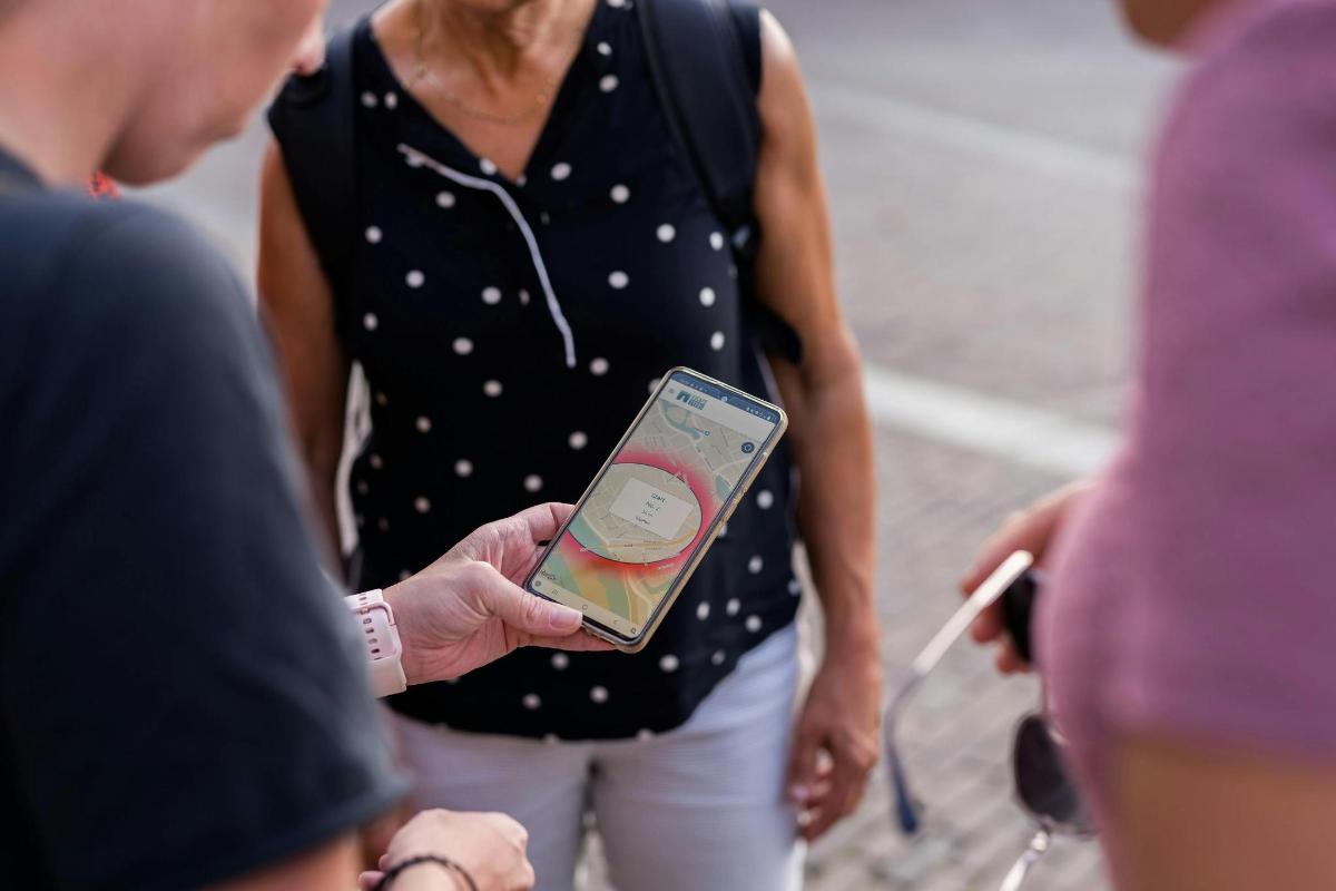 a woman holding a cell phone in her hand
