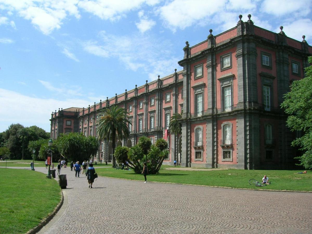 a large brick building with people walking in front of it