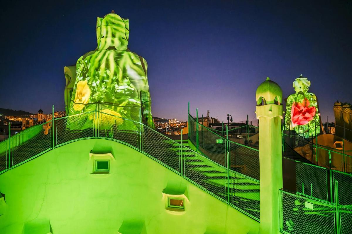 a green building with a statue on top of it