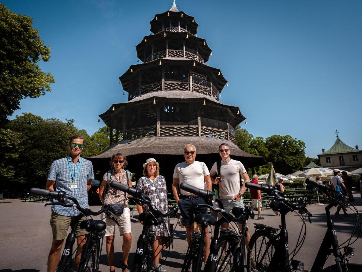 a group of people on bikes in front of a tower