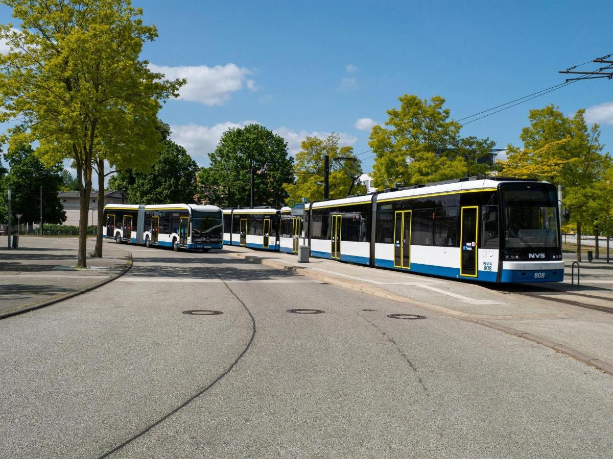 three buses parked in a row on a street