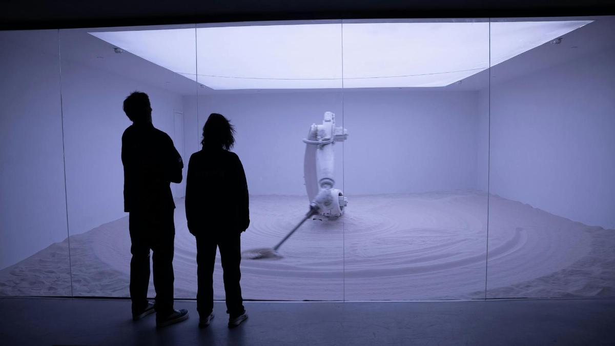 two people standing in front of a museum exhibit