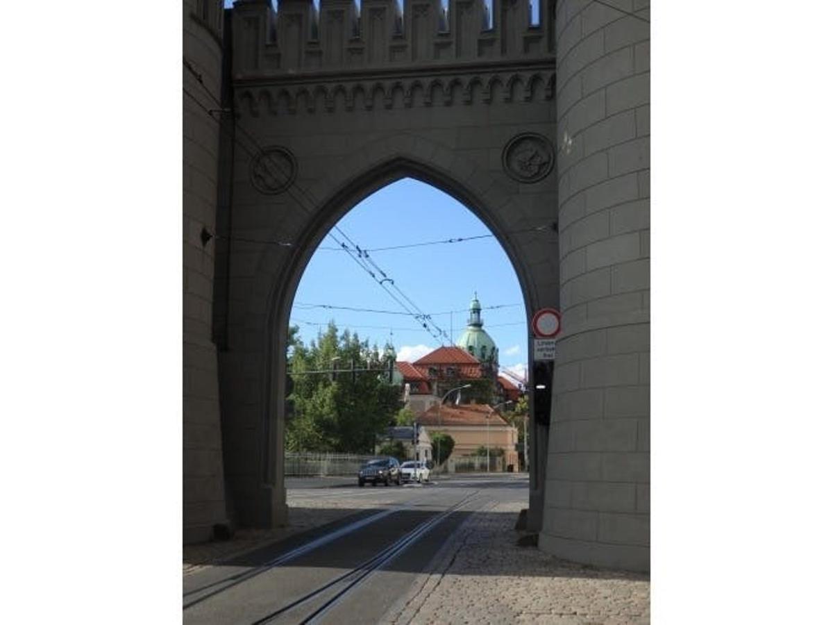 an archway over a street with a building in the background