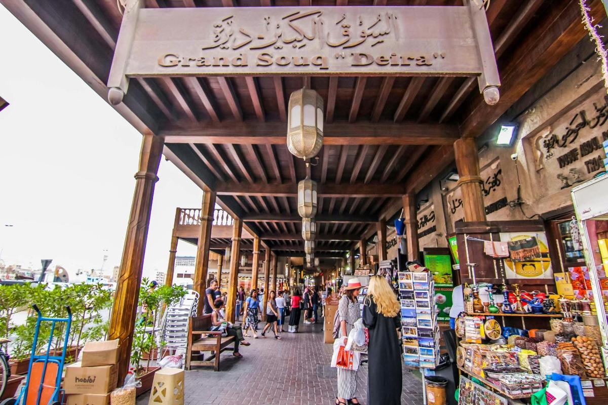 a group of people walking through a market