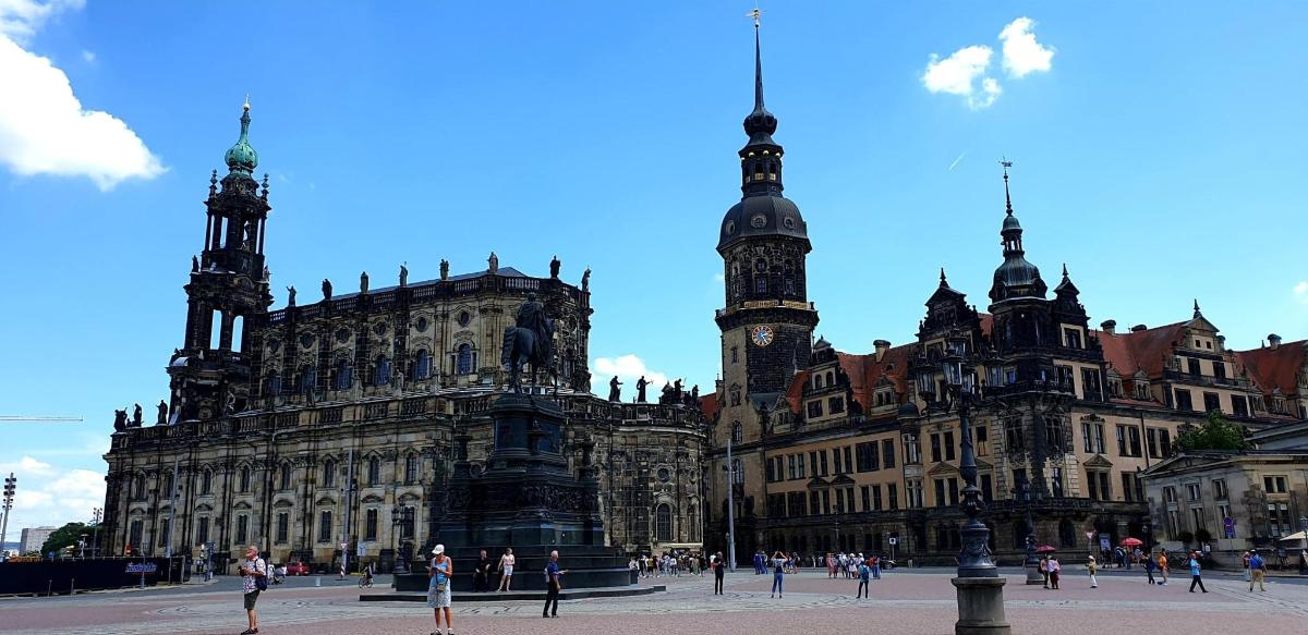a large building with a clock tower in front of it