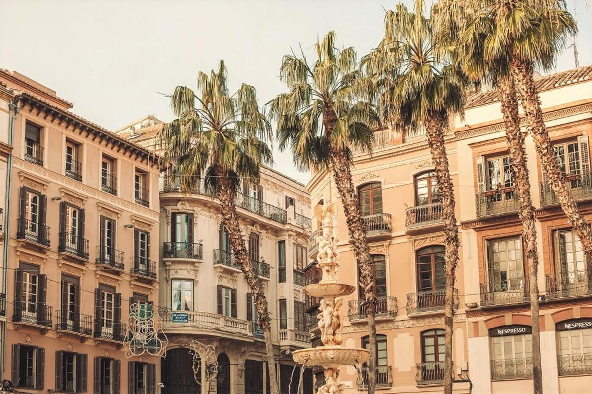 a group of palm trees in front of a building