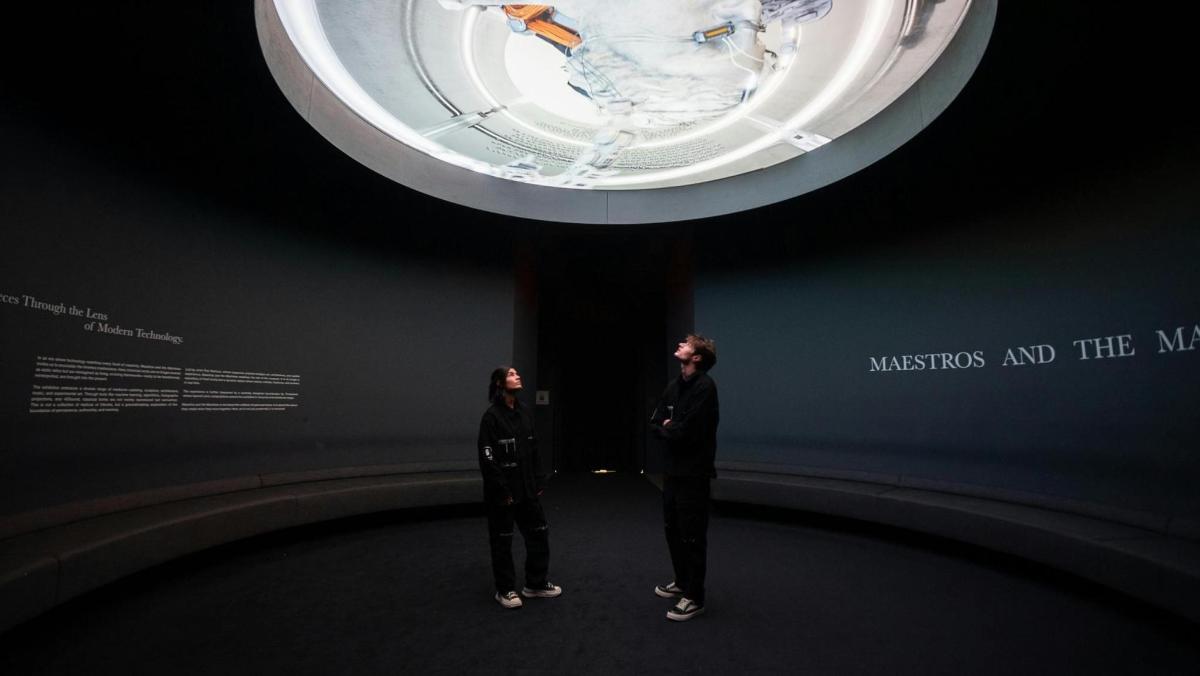 two people standing in front of a room with a ceiling