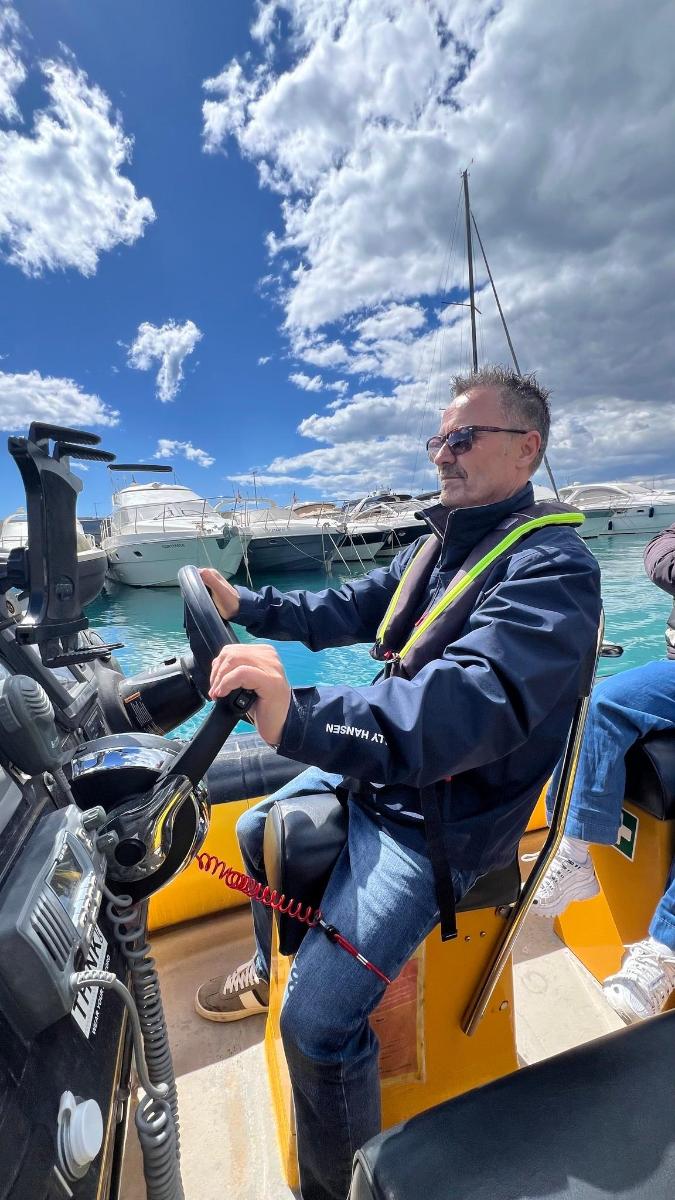 a man sitting on a boat in the water