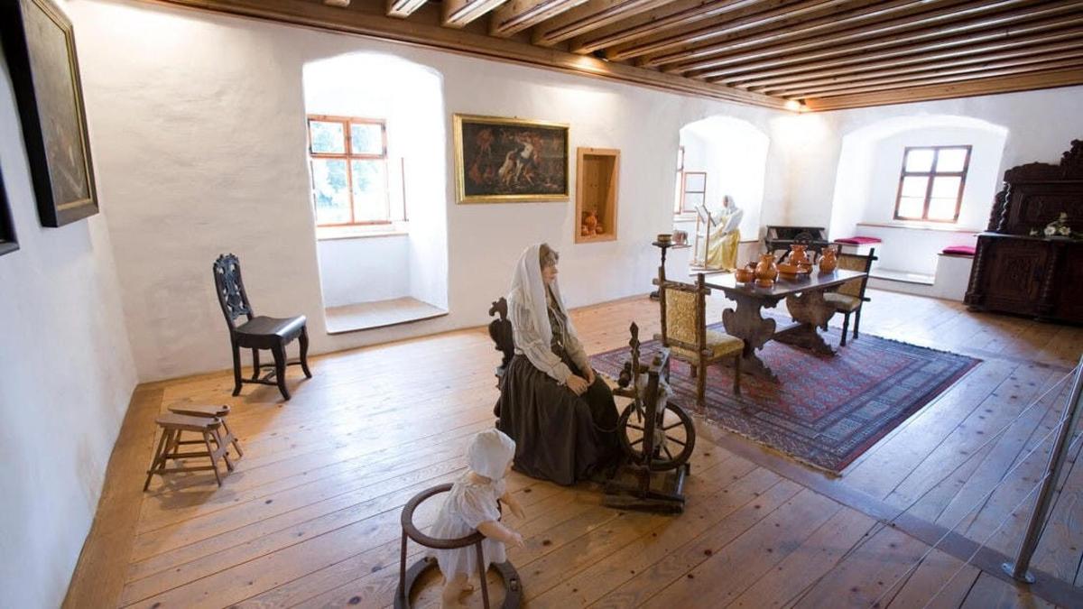 a large living room with a table and chairs