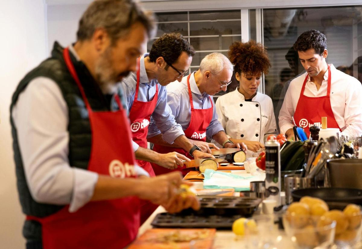 a group of people in a kitchen preparing food