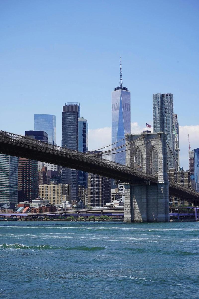 a bridge over the water with a city in the background