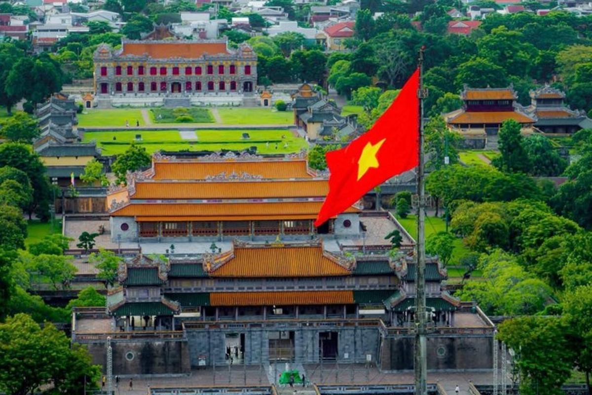 a flag flying in front of a large building