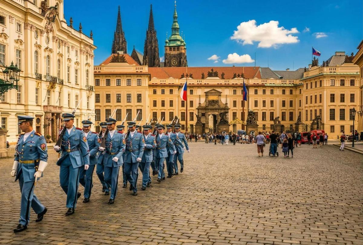 a group of men in blue uniforms walking down a street