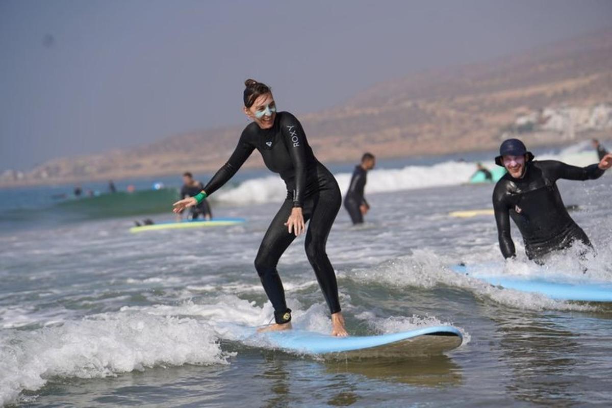 two men in wet suits riding surfboards in the ocean