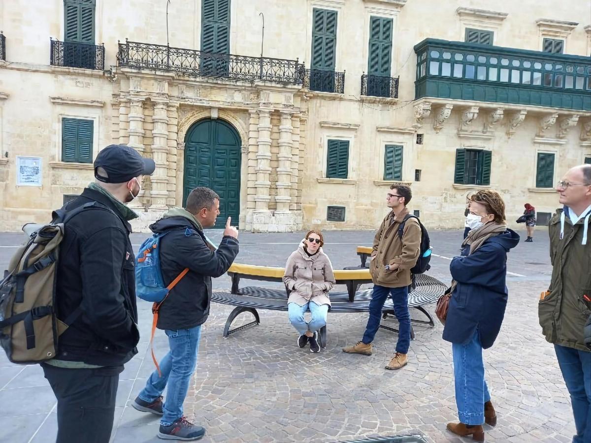 a group of people standing in front of a bench