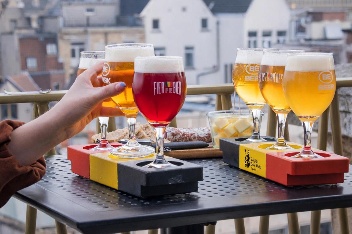 a group of four glasses of beer on a table