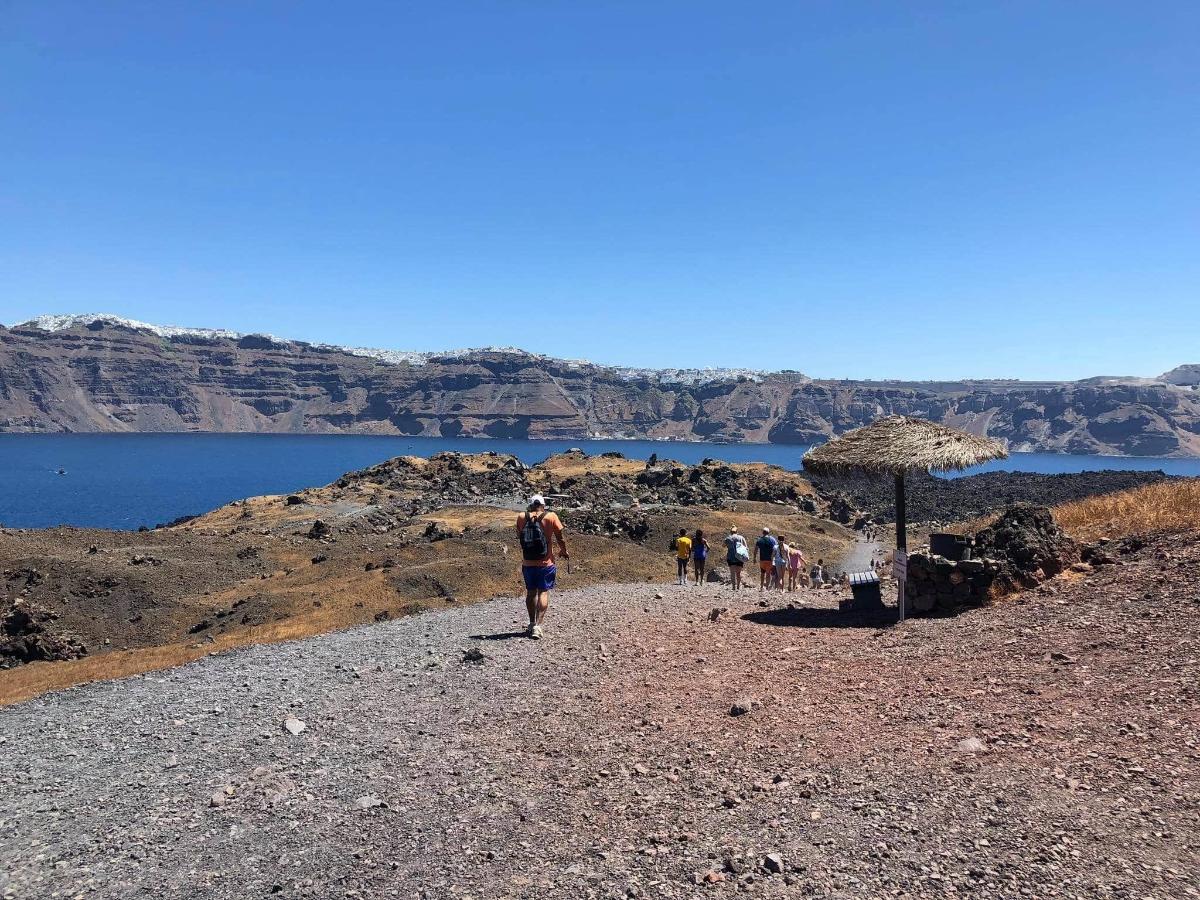 a group of people walking down a rocky trail