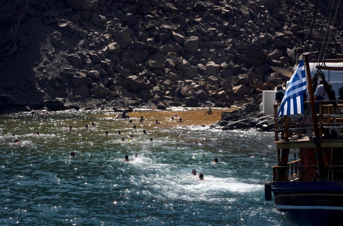 a group of people in the water at a beach