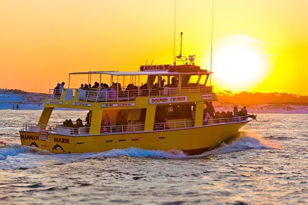 a ferry boat in the water at sunset