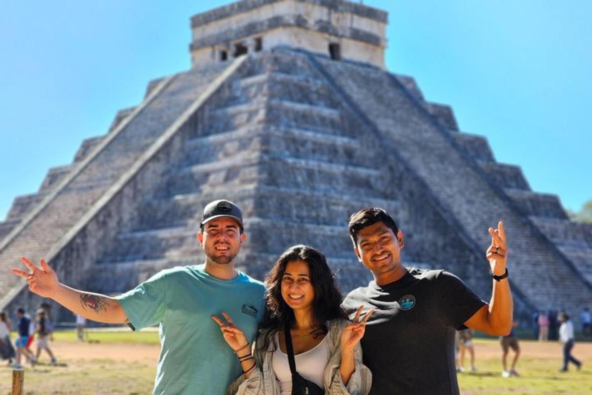three people posing in front of the pyramid