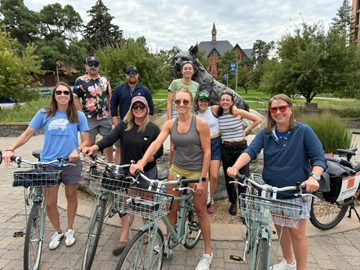a group of people posing with their bikes