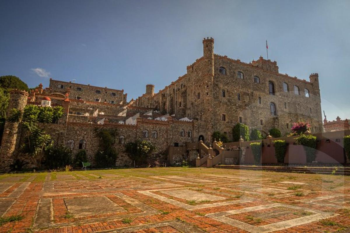 a large castle with a stone courtyard in front of it