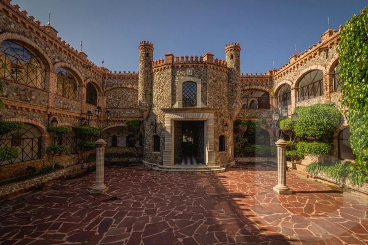 a large building with a brick courtyard with a doorway