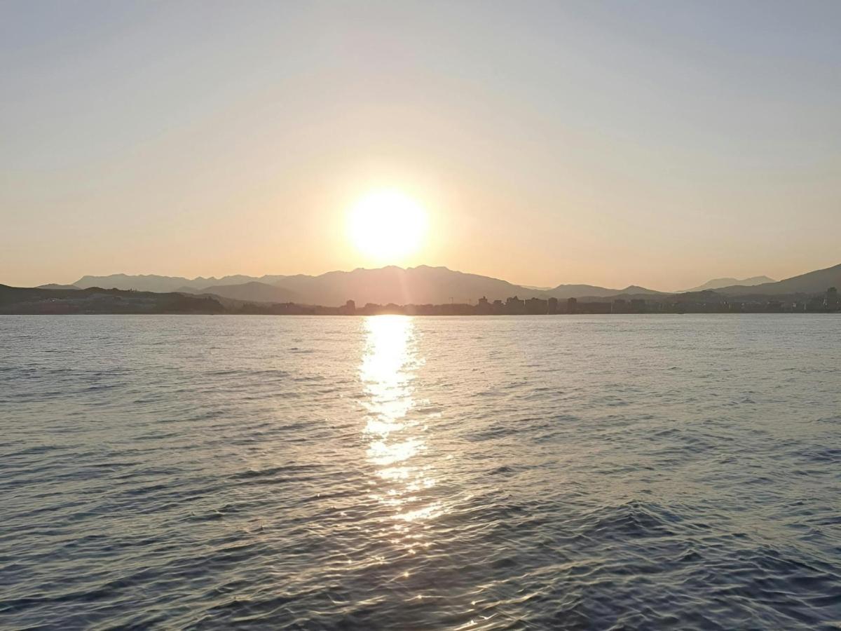 a sun setting over a body of water