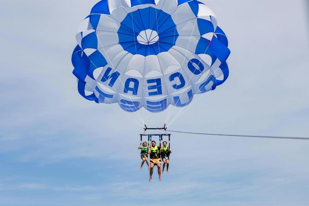 a group of people on a blue and white parachute
