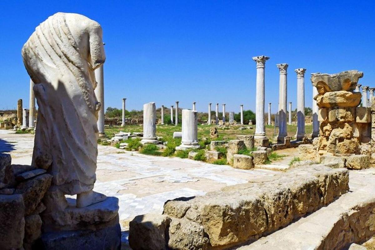 a statue in front of a bunch of columns