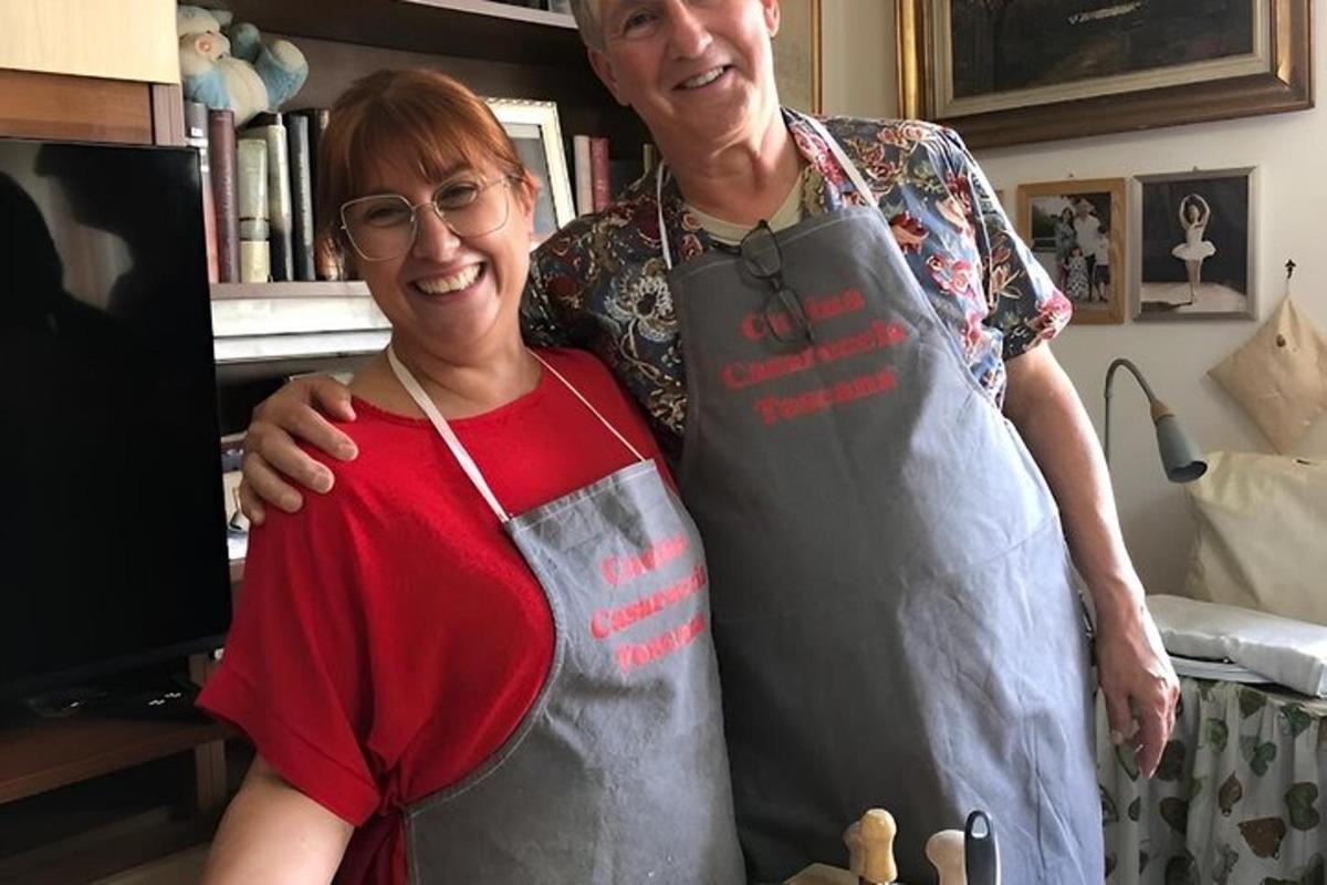 a man and a woman in a kitchen wearing an apron