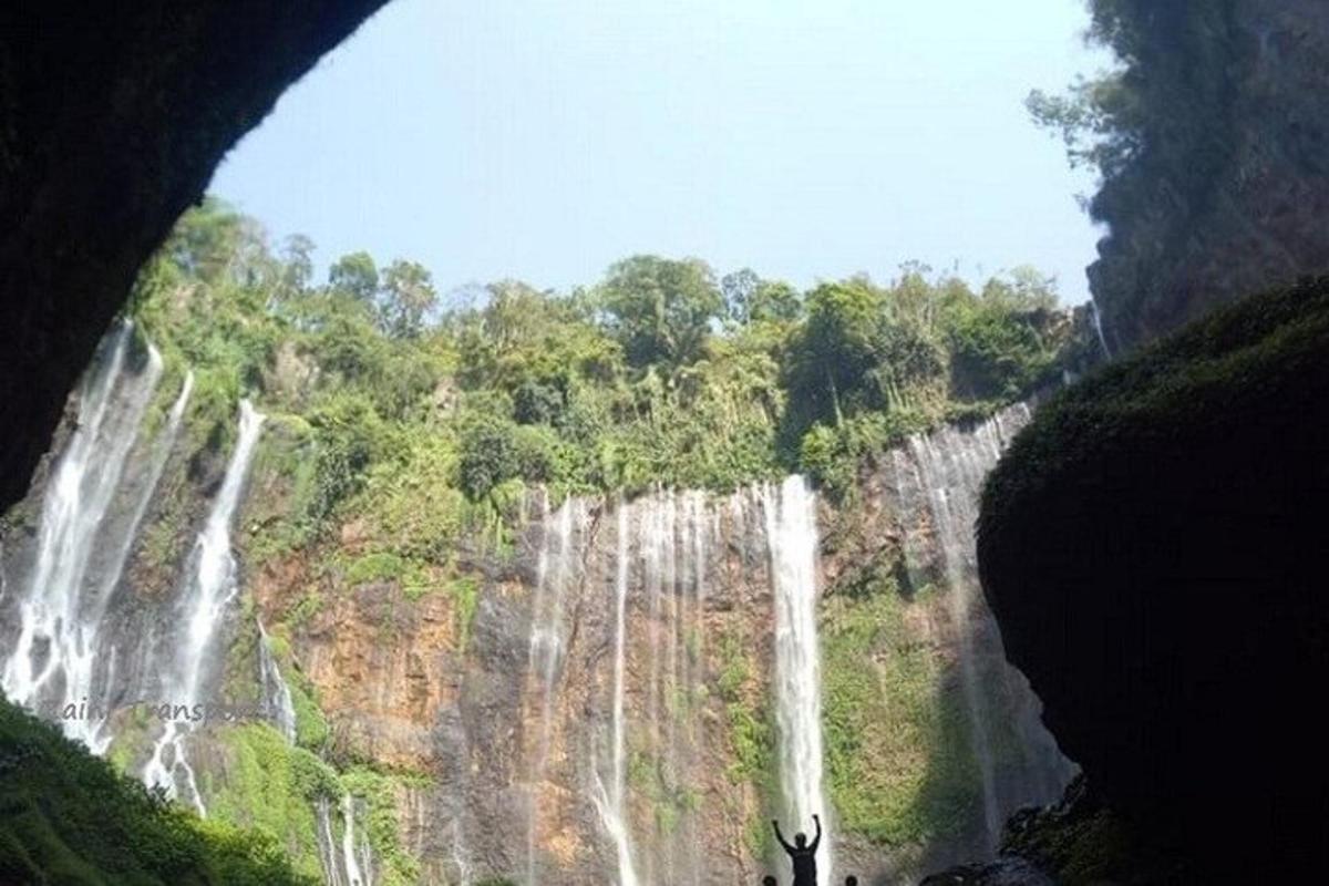 a view of a waterfall from inside a cave
