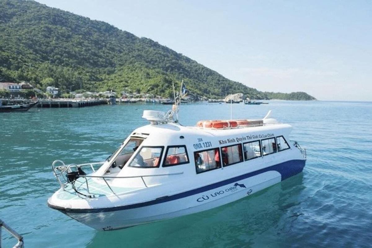 a white boat in the water on a lake
