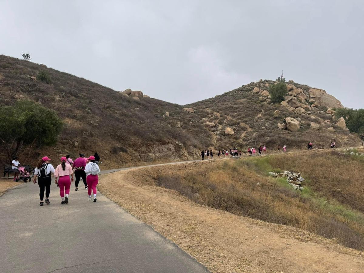 a group of people walking down a road