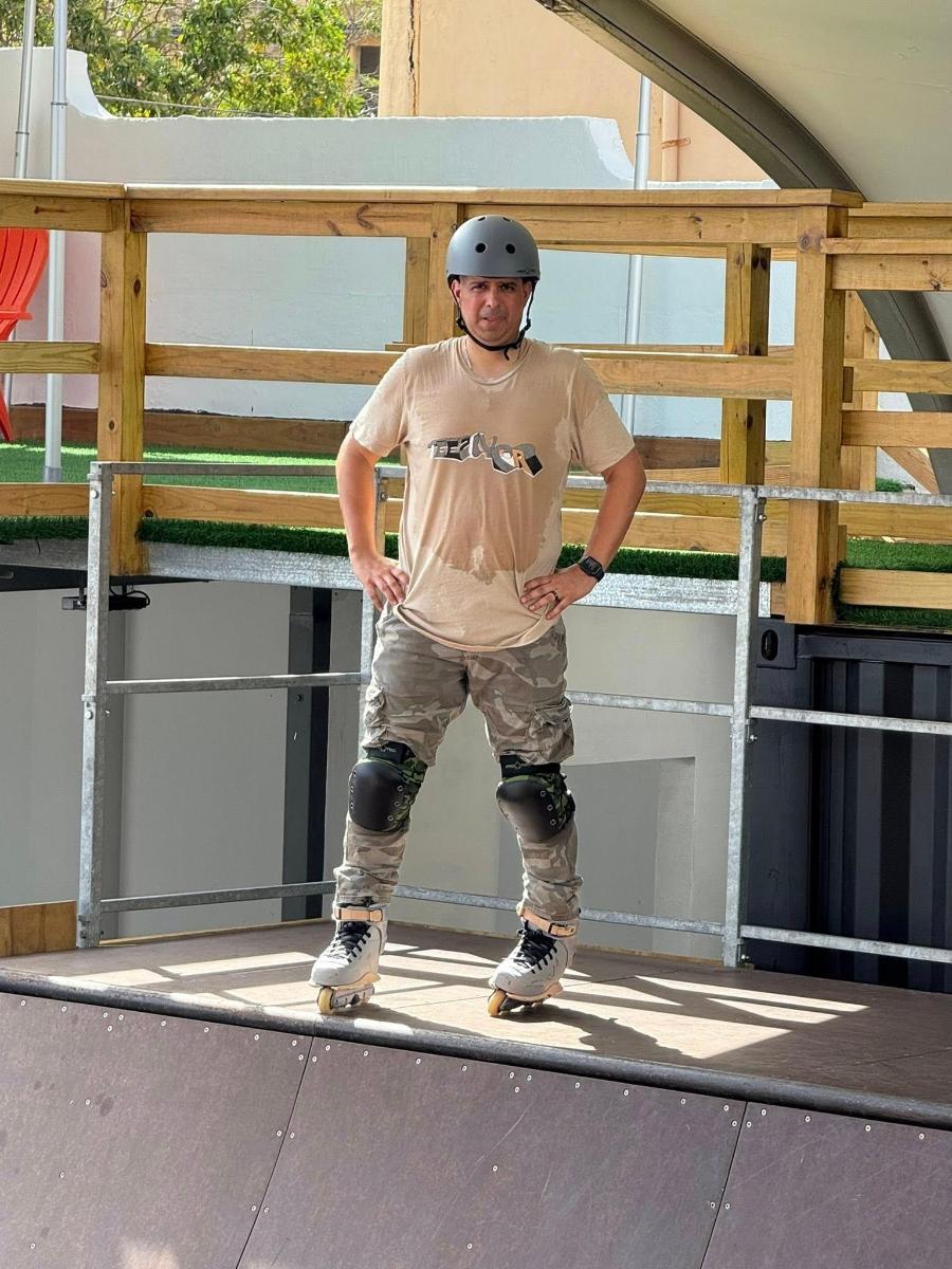 a man standing on top of a skateboard ramp