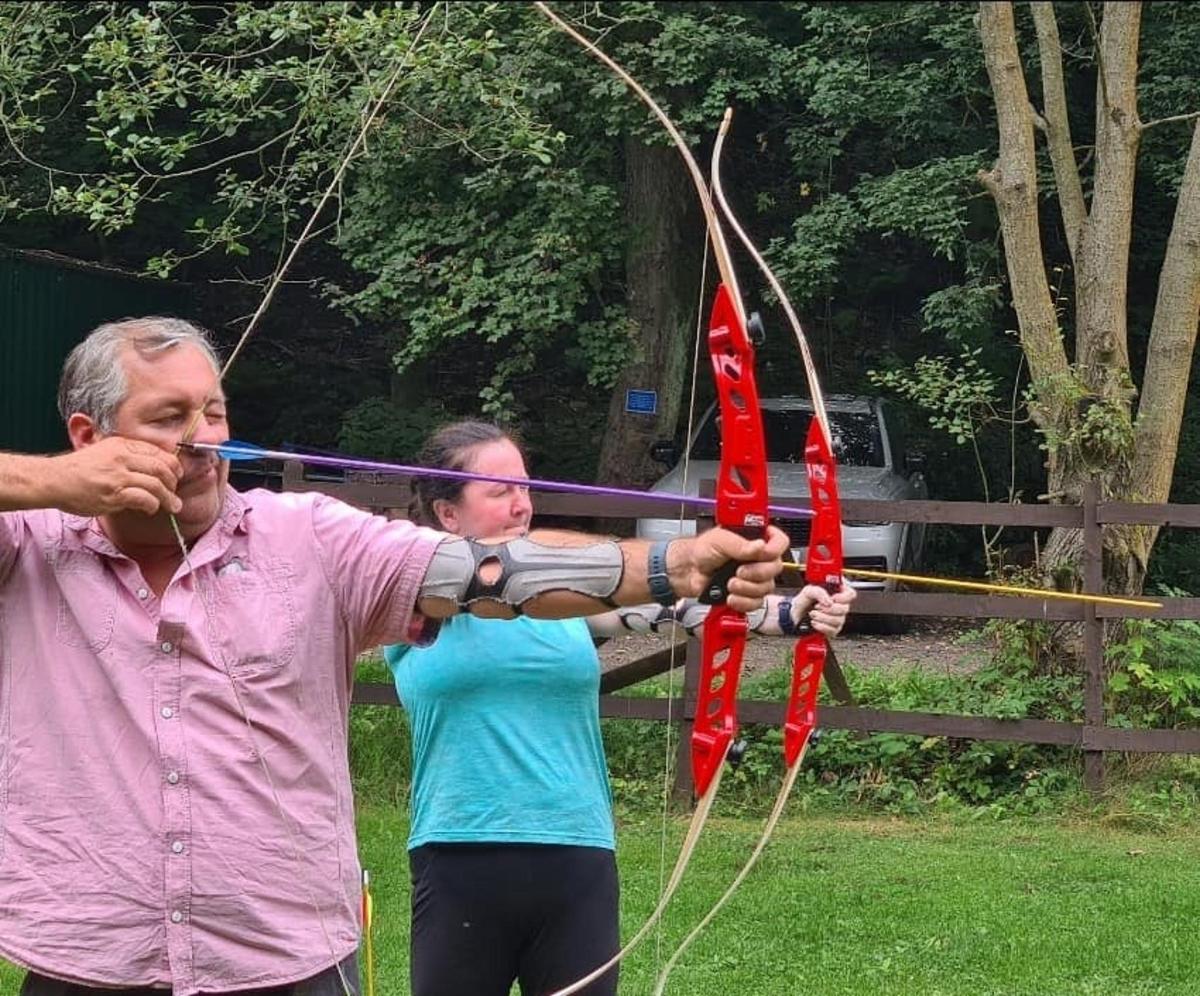 a man and a woman holding a bow and arrow