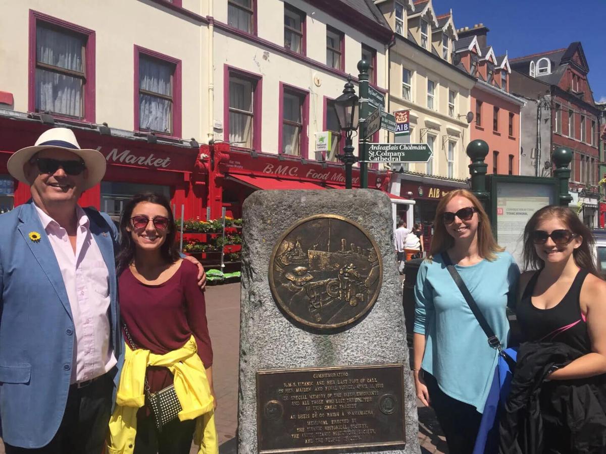 a group of people standing in front of a monument