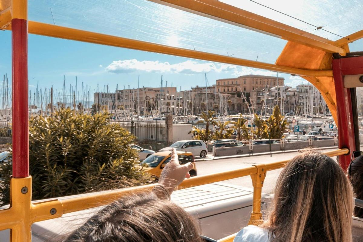 a group of people looking out a window at a harbor