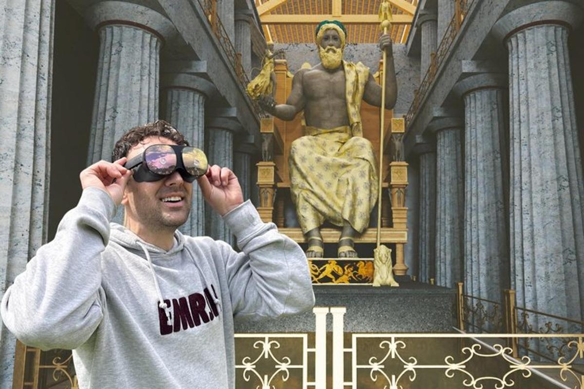 a man looking through a pair of binoculars in front of a statue