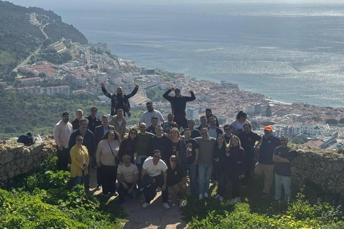 a group of people standing on top of a mountain