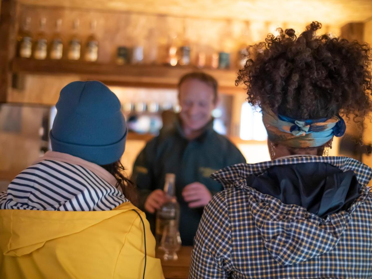 a group of people standing in a barber shop
