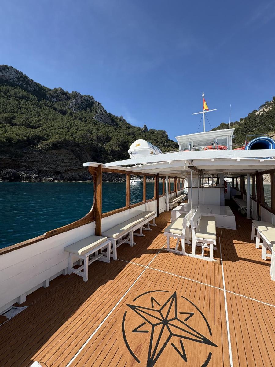 a deck of a boat with benches on the water