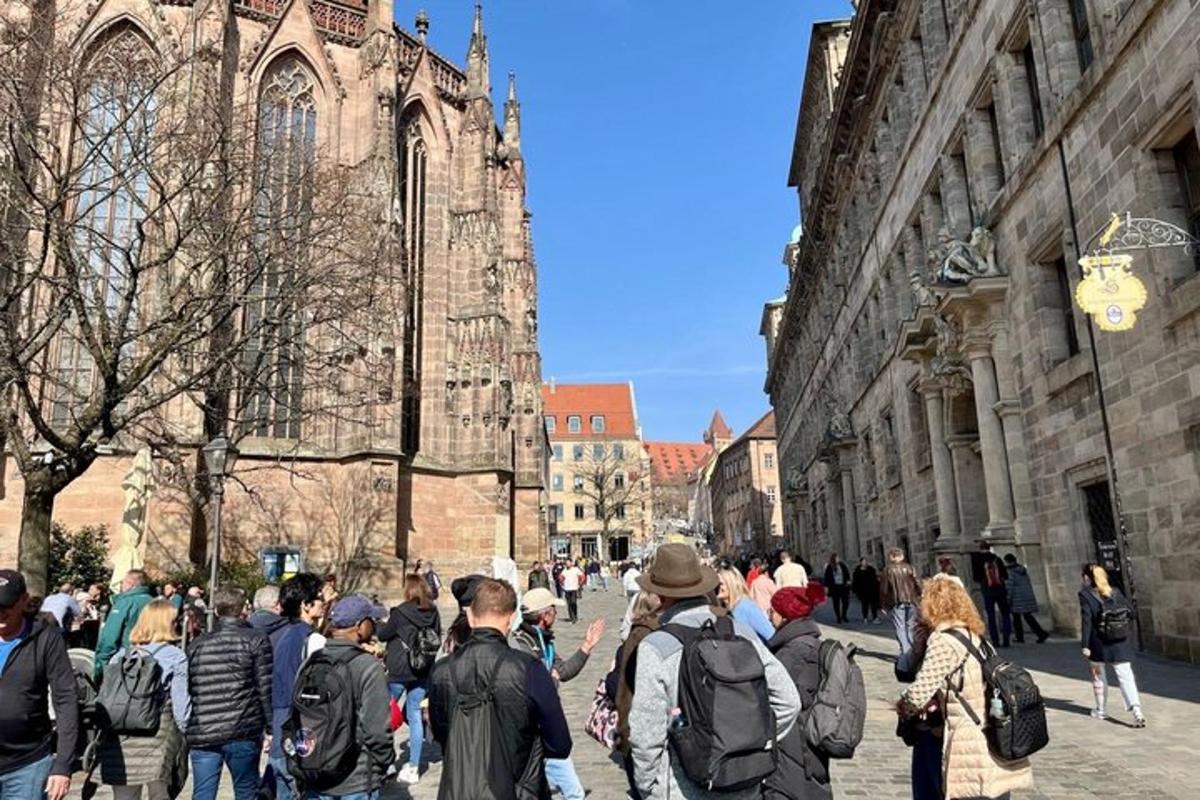 a group of people walking in front of a cathedral