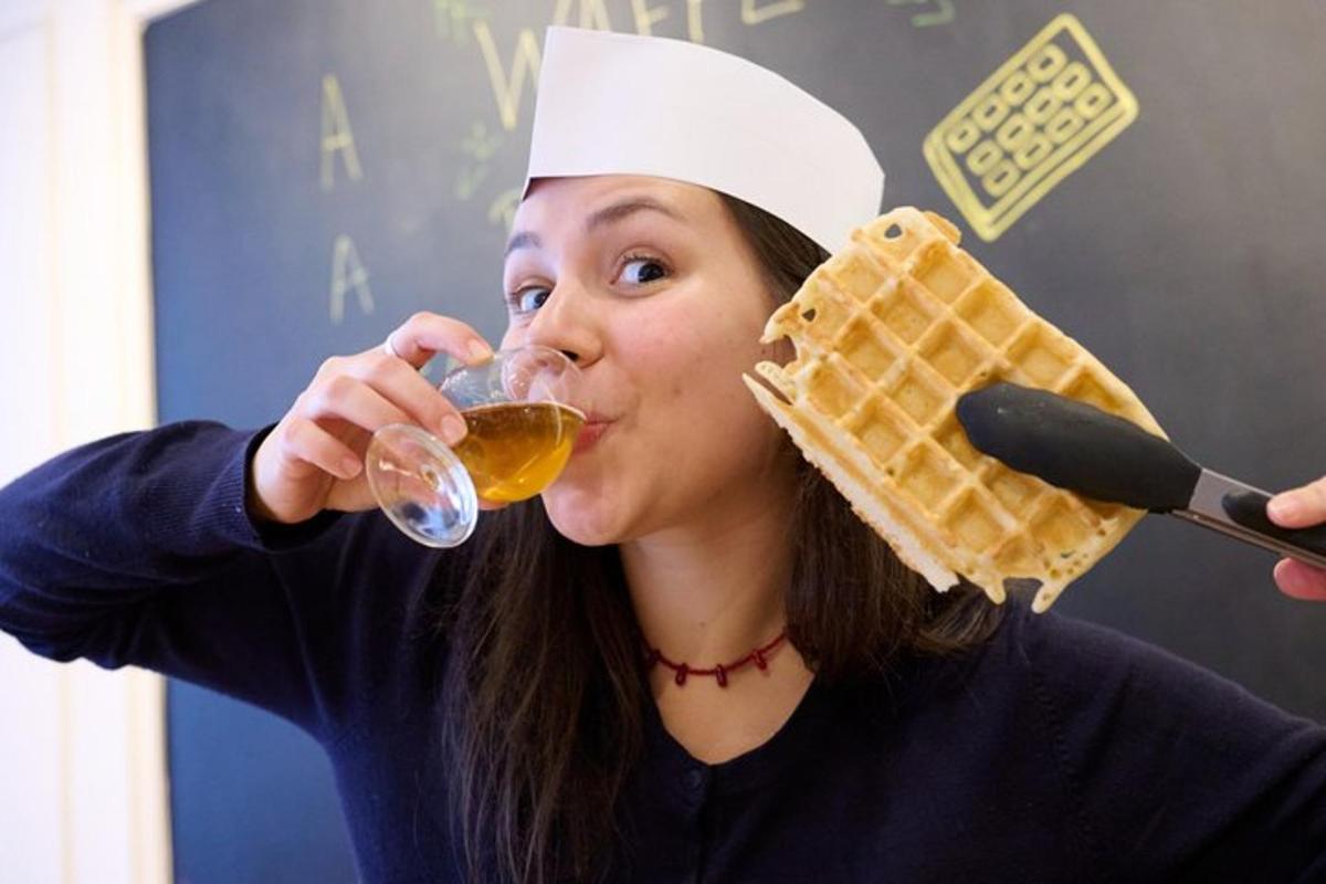 a woman in a chefs hat drinking from a waffle