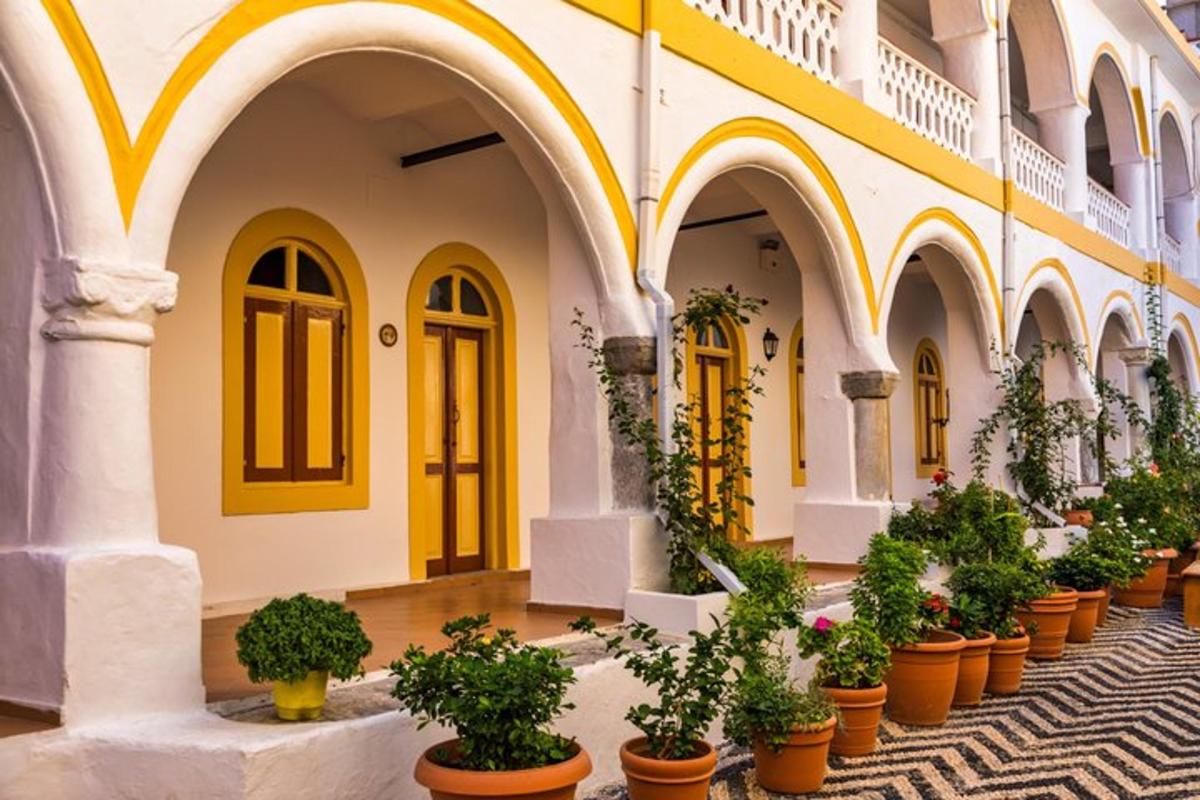 a courtyard with potted plants inront of a building
