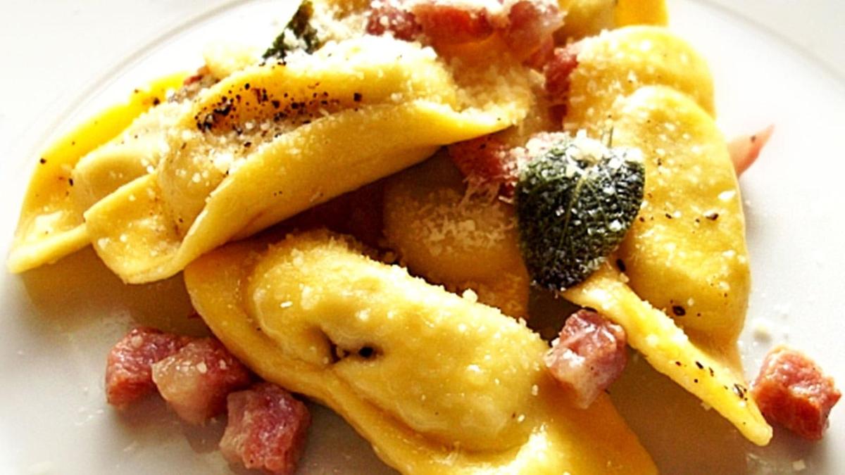 a white plate of food with pasta and broccoli